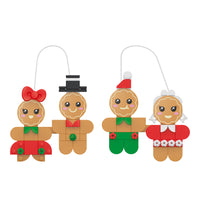 Set of four gingerbread ornament figures with decorative clothing on a white background