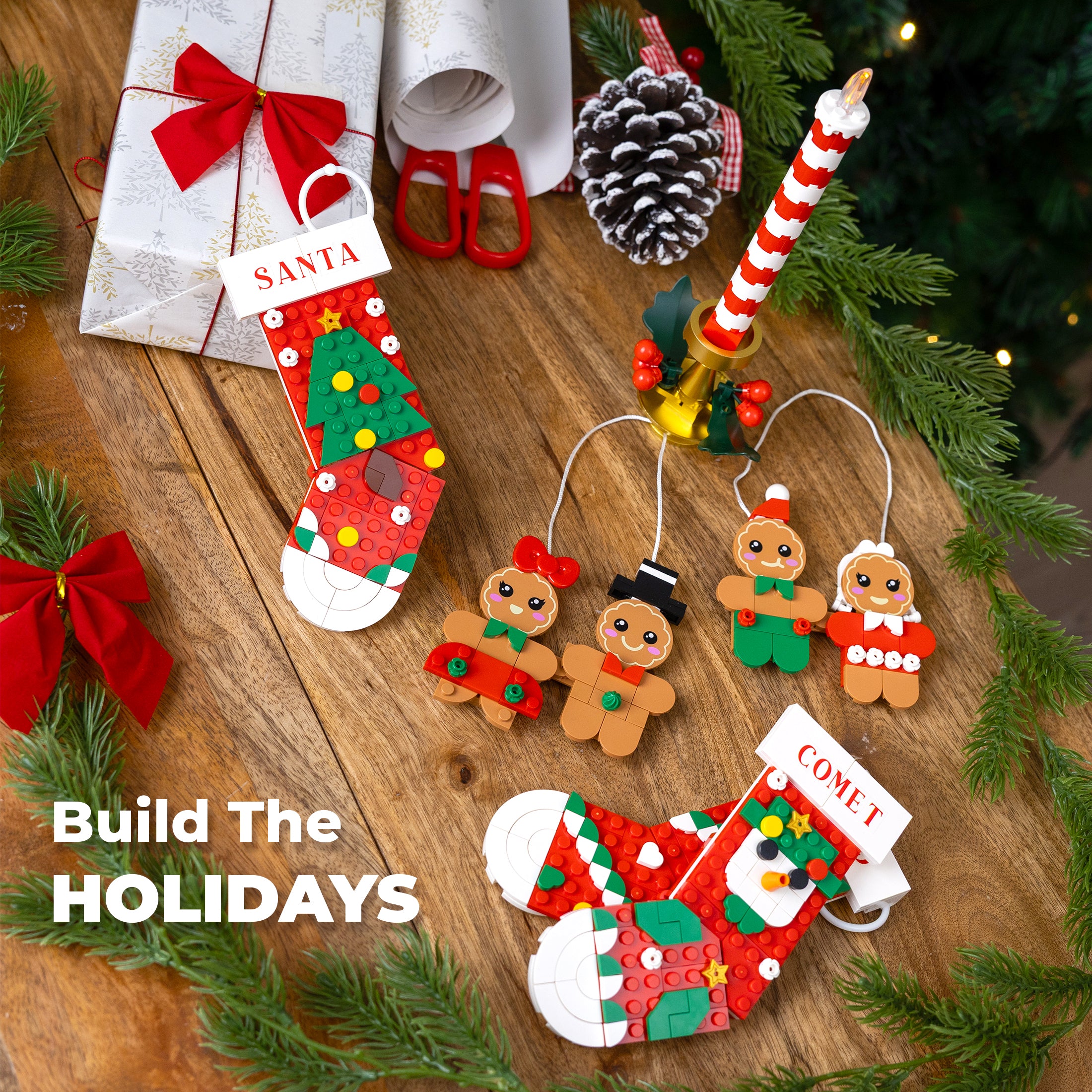 Christmas-themed decorations including a stocking, gingerbread men, and a candy cane on a wooden surface with greenery.