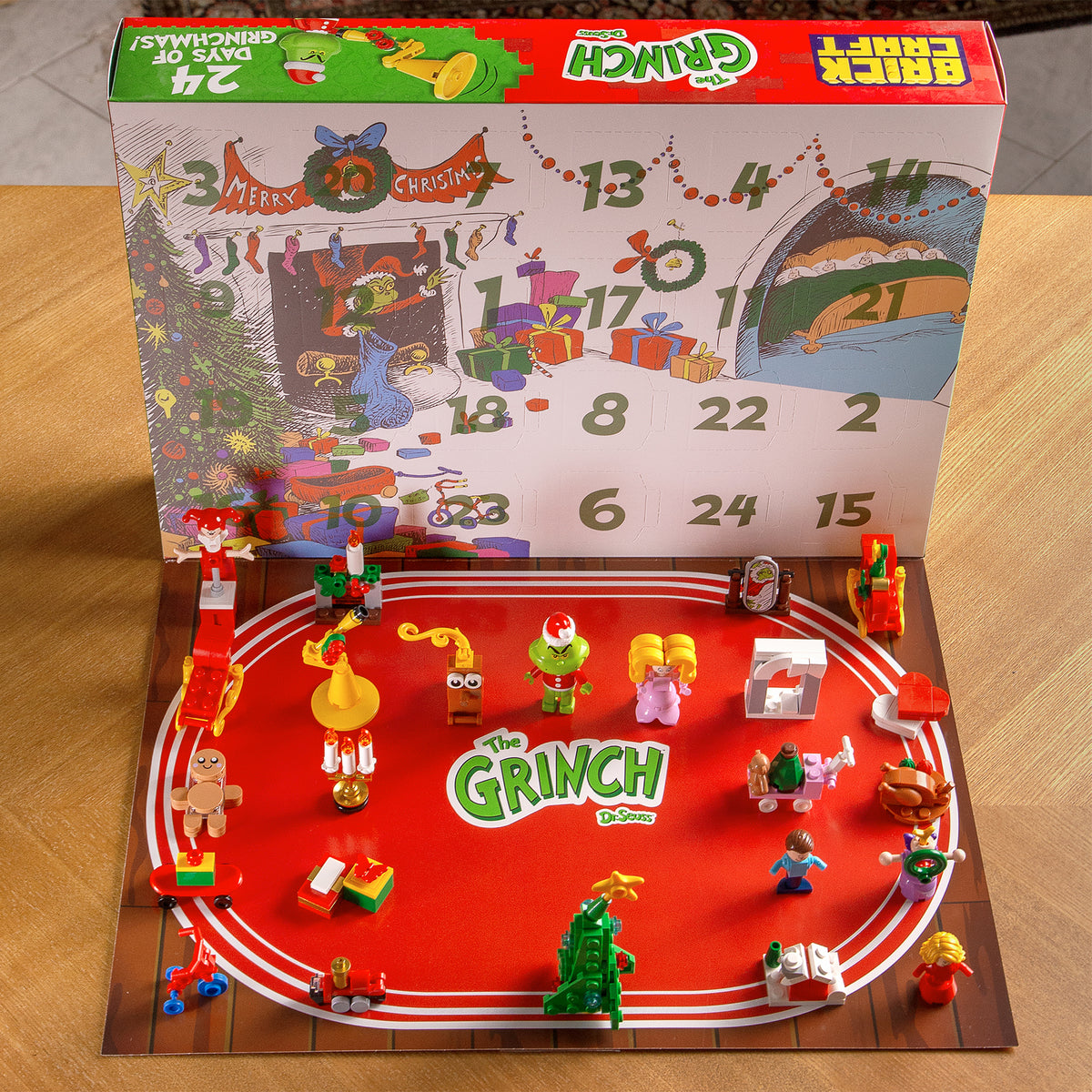 Advent calendar with 'The Grinch' theme featuring figurines and a countdown display.
