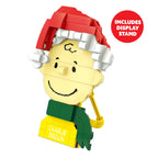 Toy figure of Charlie Brown with a Santa hat on a white background