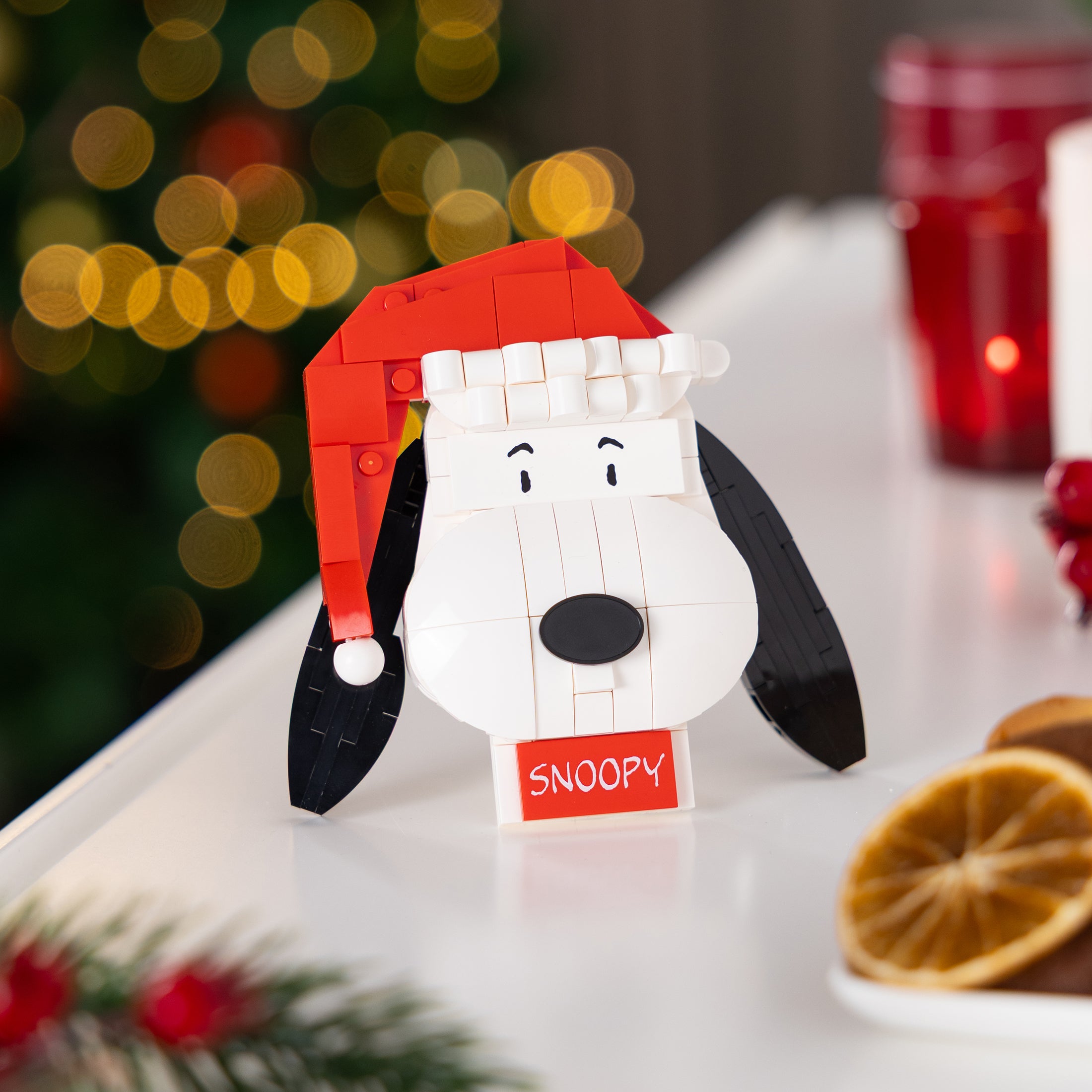Snoopy figurine with a Santa hat on a festive background