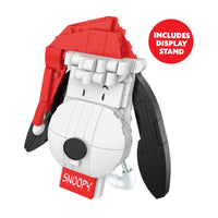 Snoopy figurine with a red hat and display stand on a white background