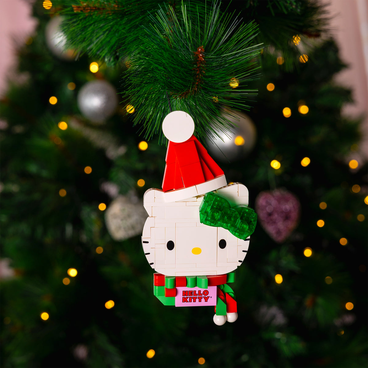 Hello Kitty Christmas ornament with a Santa hat on a decorated tree