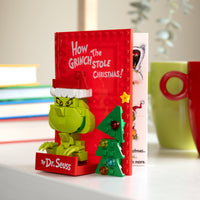 Toy set of 'How the Grinch Stole Christmas!' book with Grinch figure on a shelf.