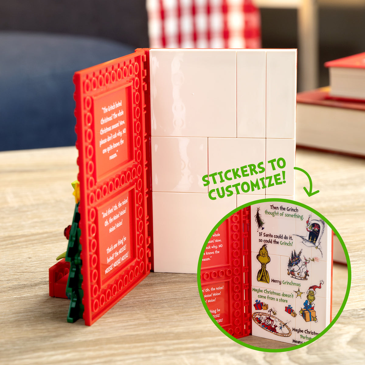Customizable book with red and white pages, stickers, and a Grinch illustration on a wooden surface.
