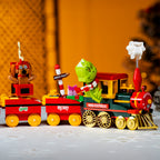 Toy train set with characters and Christmas-themed decorations.