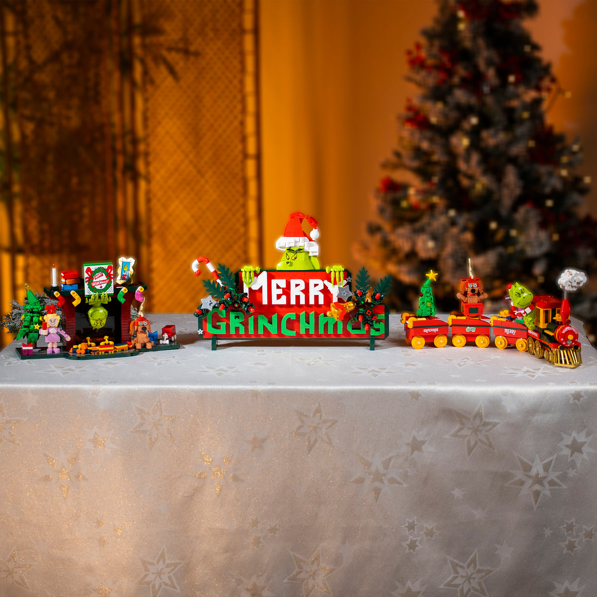 Christmas-themed toy set with a 'GRINCH' sign on a decorative surface.