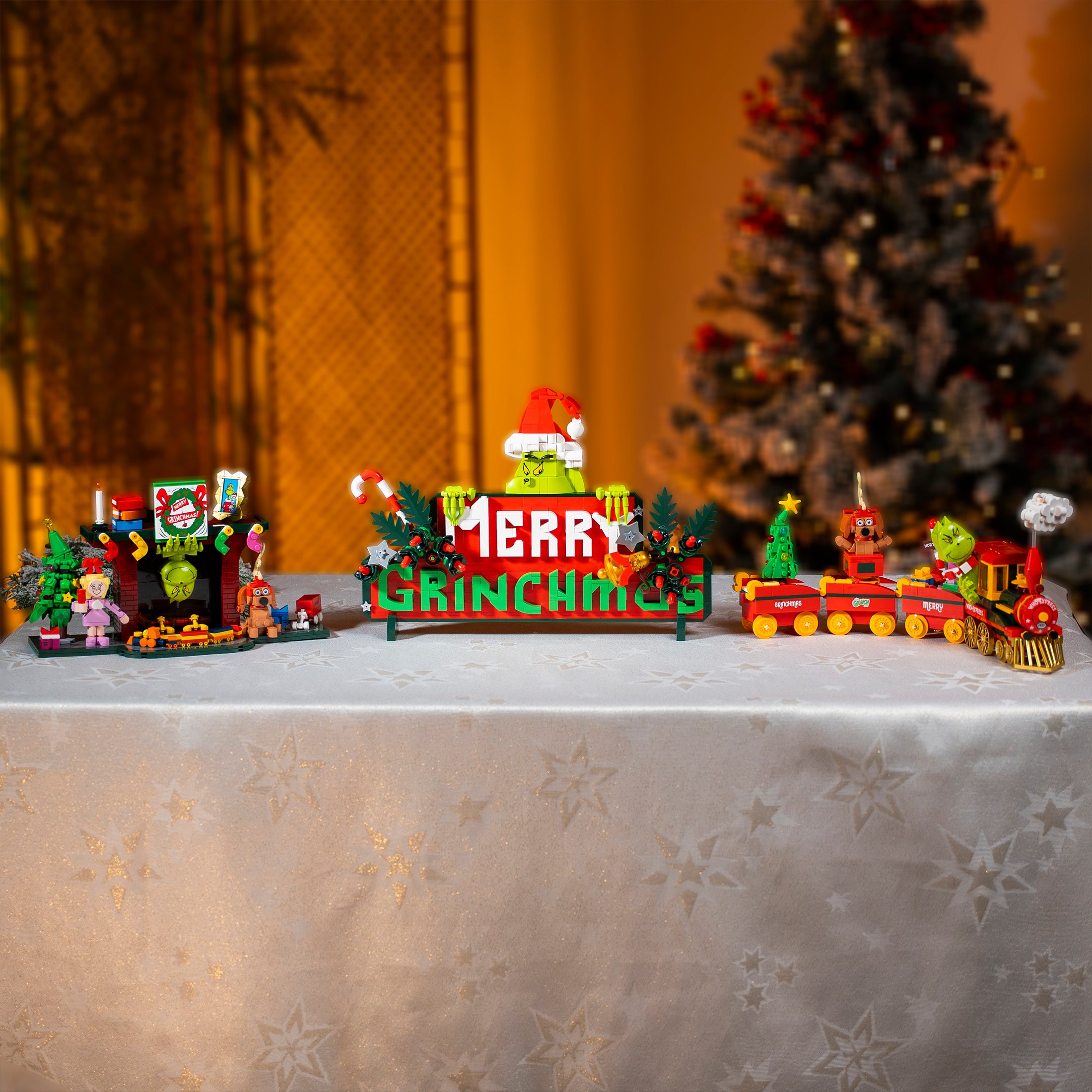 Christmas-themed toy set with a 'GRINCH' sign on a decorative surface.