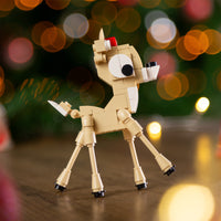 Toy reindeer figure with a blurred festive background