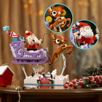 Christmas-themed toy set with Santa Claus, reindeer, and sleigh on a wooden table.