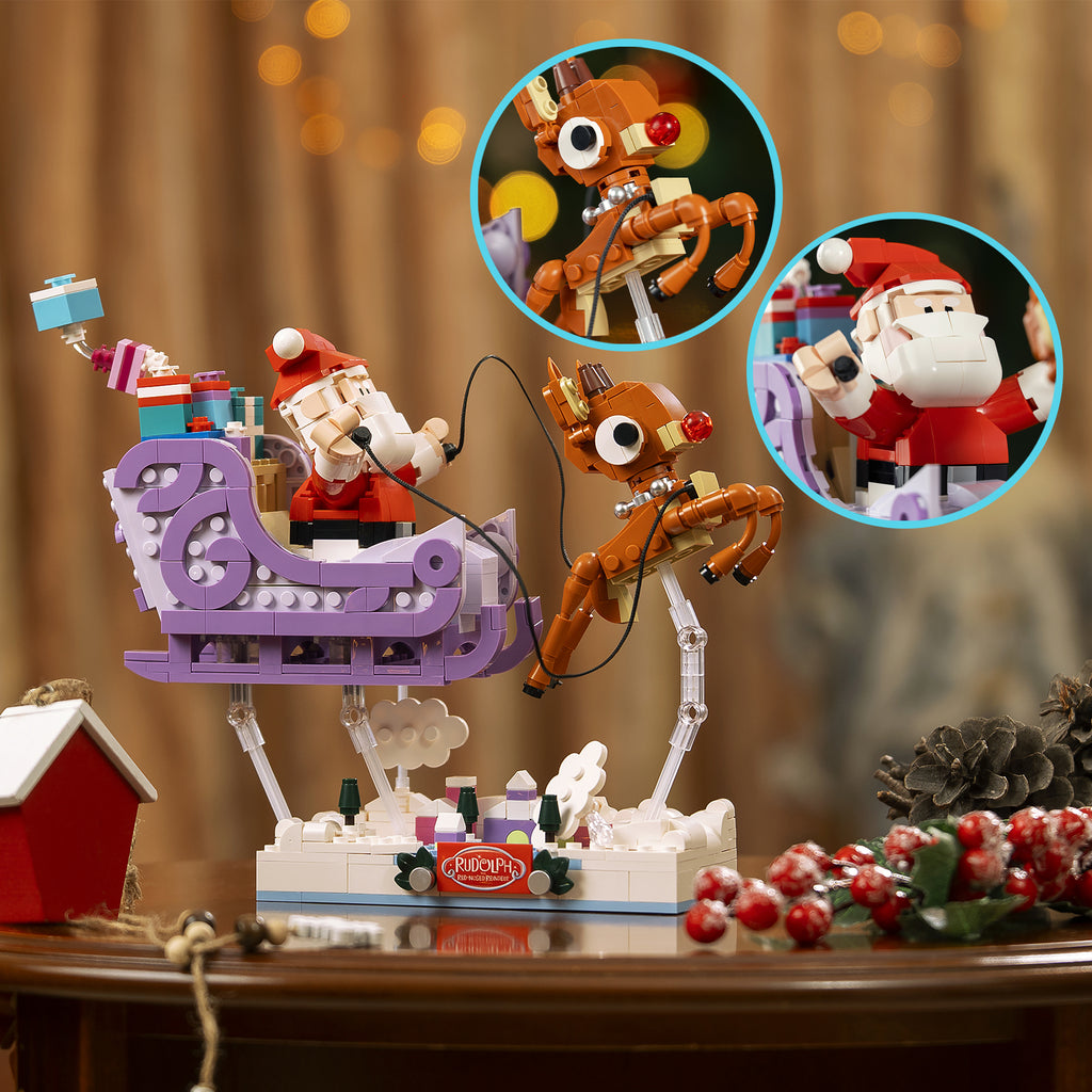 Christmas-themed toy set with Santa Claus, reindeer, and sleigh on a wooden table.