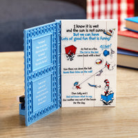 Children's book with colorful illustrations and text on a wooden surface