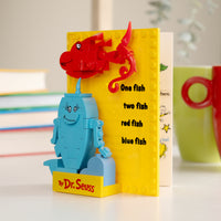 Toy figure of a fish and cat from Dr. Seuss book with colorful background