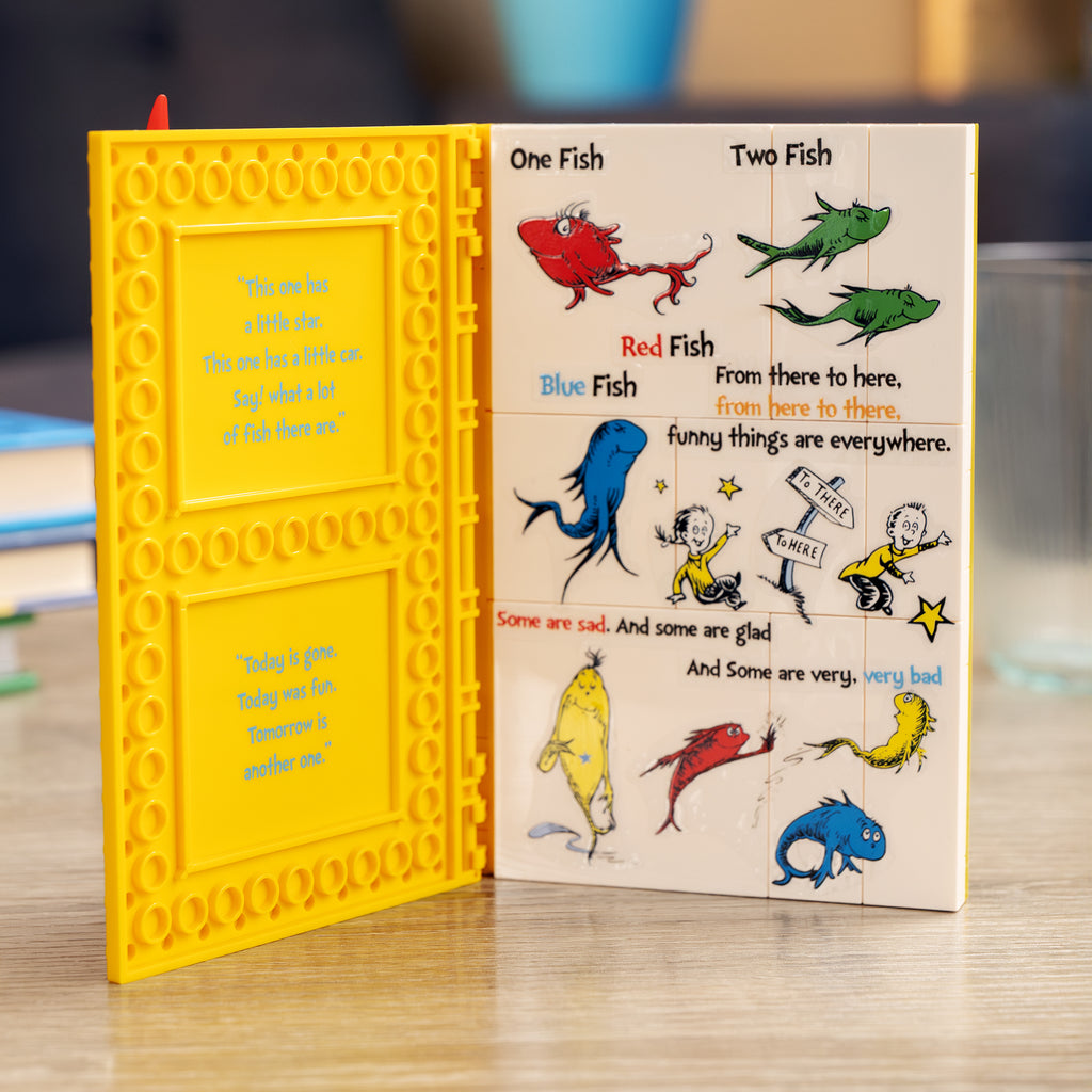 Children's book with colorful illustrations of fish and text on a wooden surface.