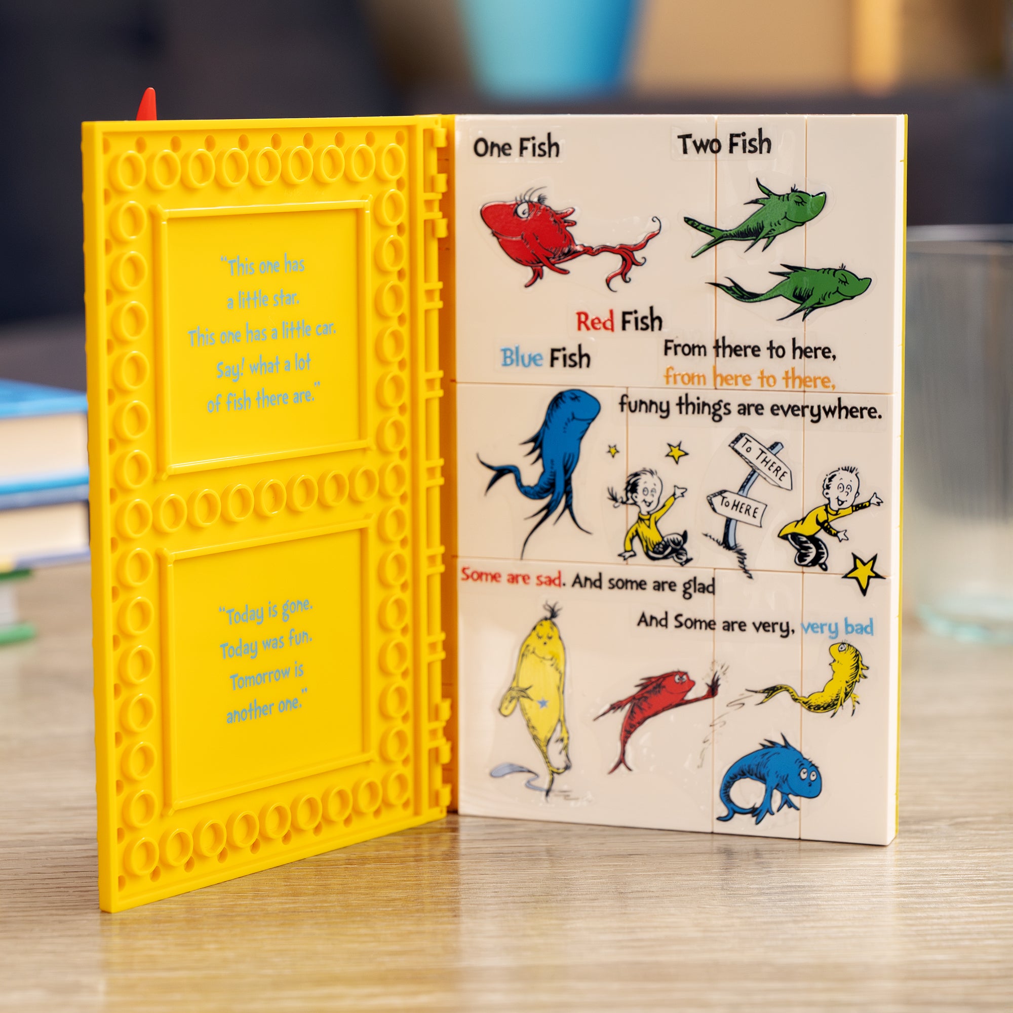 Children's book with colorful illustrations of fish and text on a wooden surface.