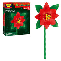 Red poinsettia flower toy on a green stem with BrickCraft packaging in the background